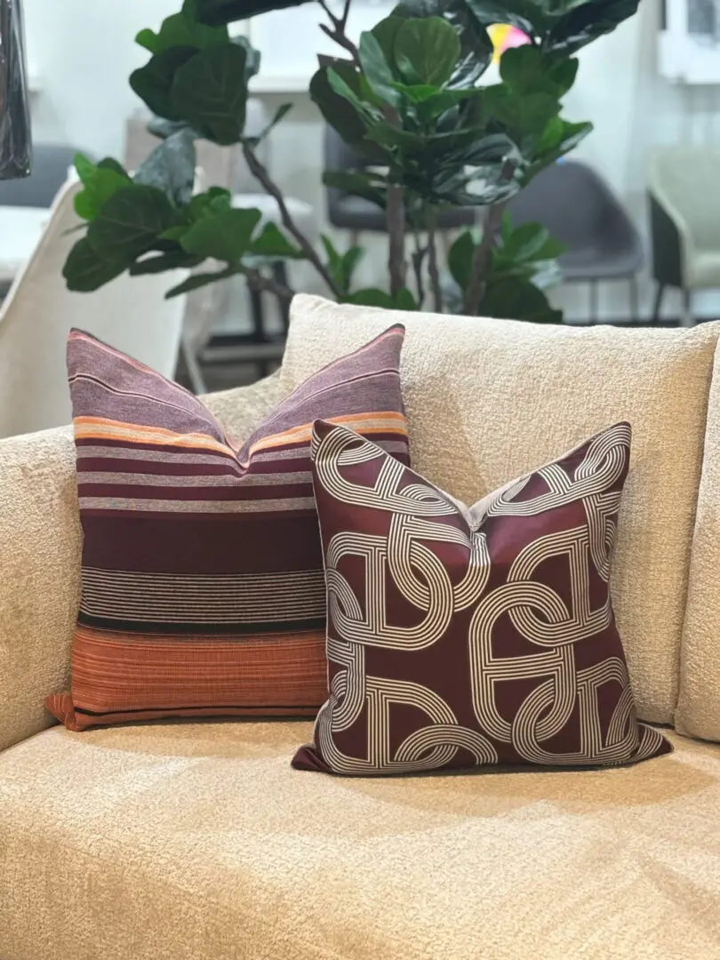 682c9b16d99f7_web pic 3 A couple of pillows on top of a couch.