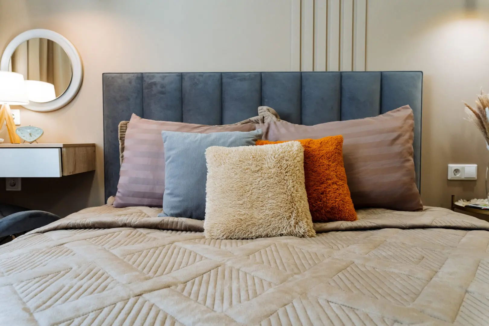 Modern bed with colorful decorative pillows.
